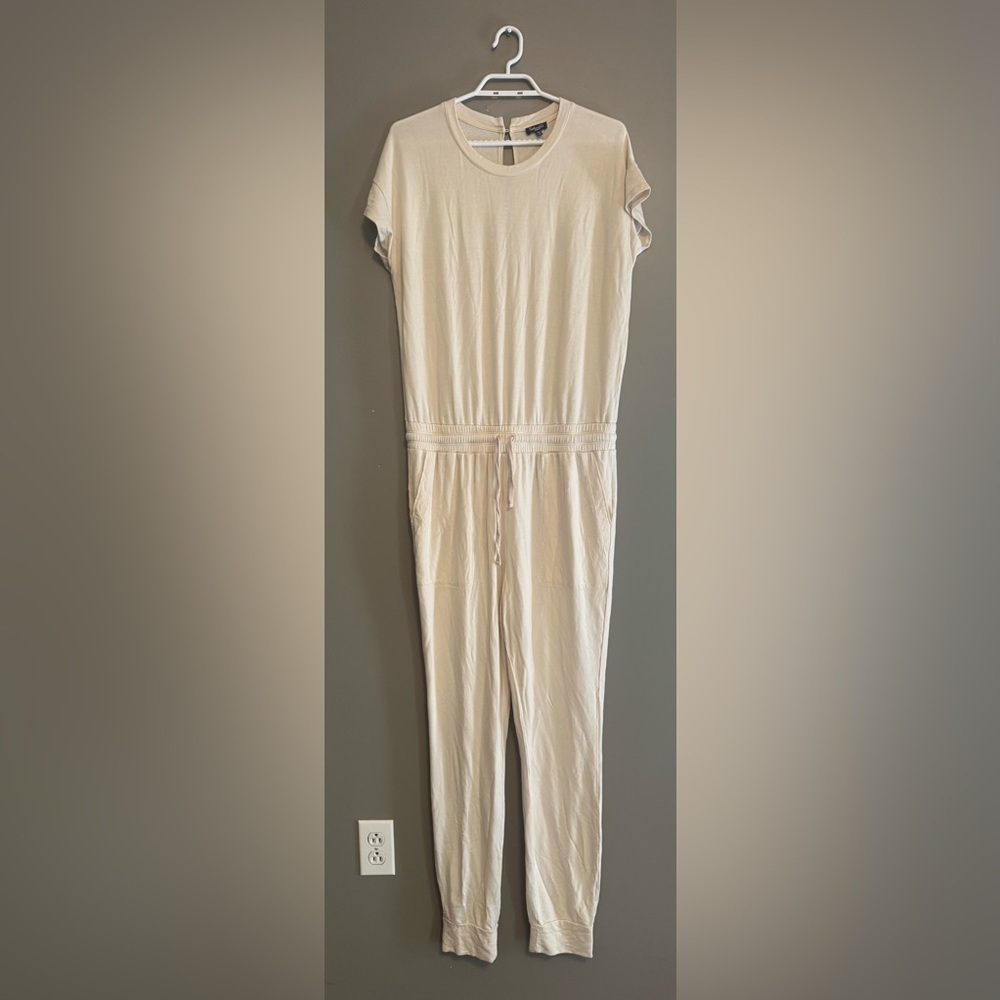 Cream Jumpsuit with Elastic Waist and pockets.